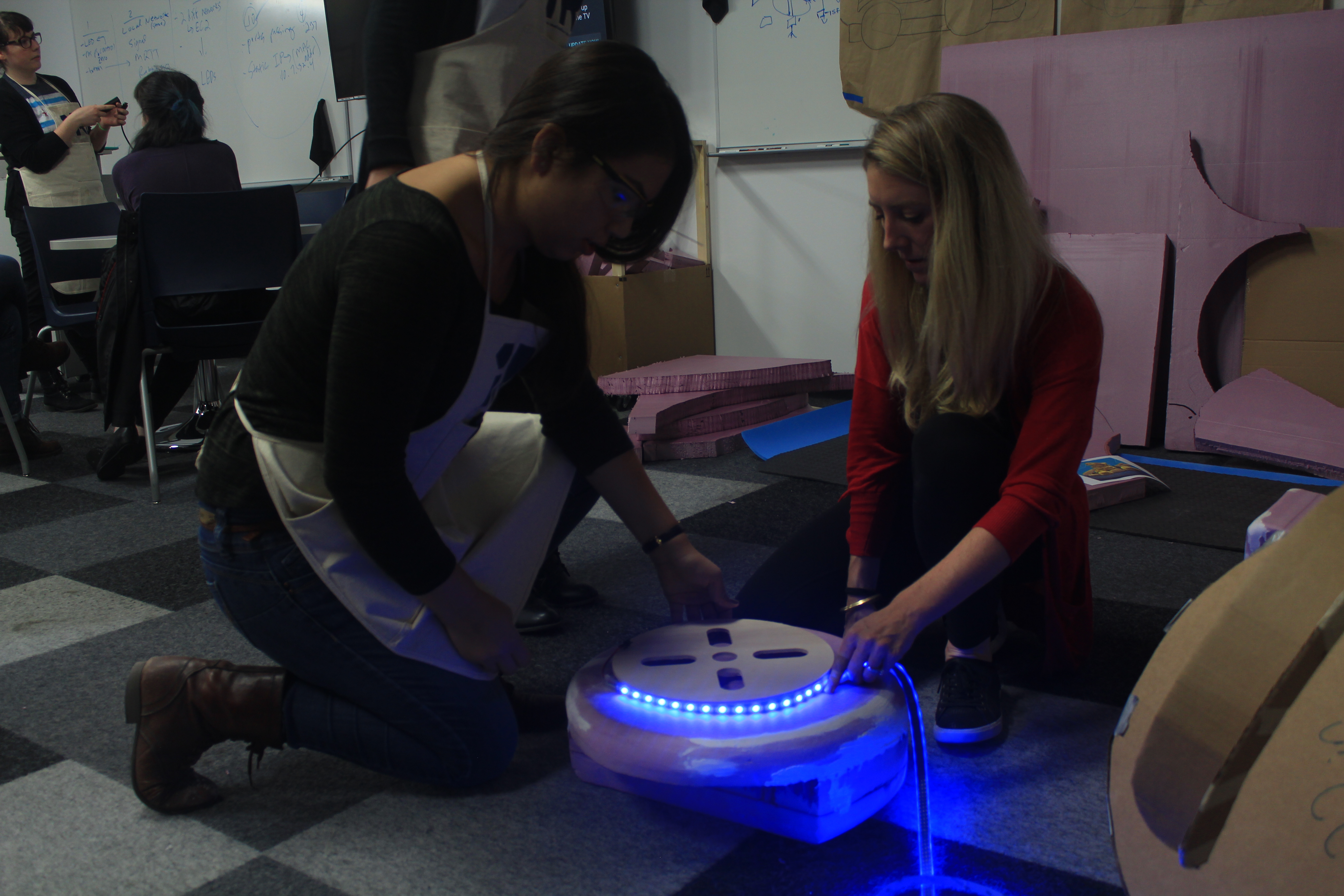 Jennifer Lawhead (left) and LeAnne Wagner (right) test the hubcap and string lights a week before the reveal. (Meredith Melland, 14 East)