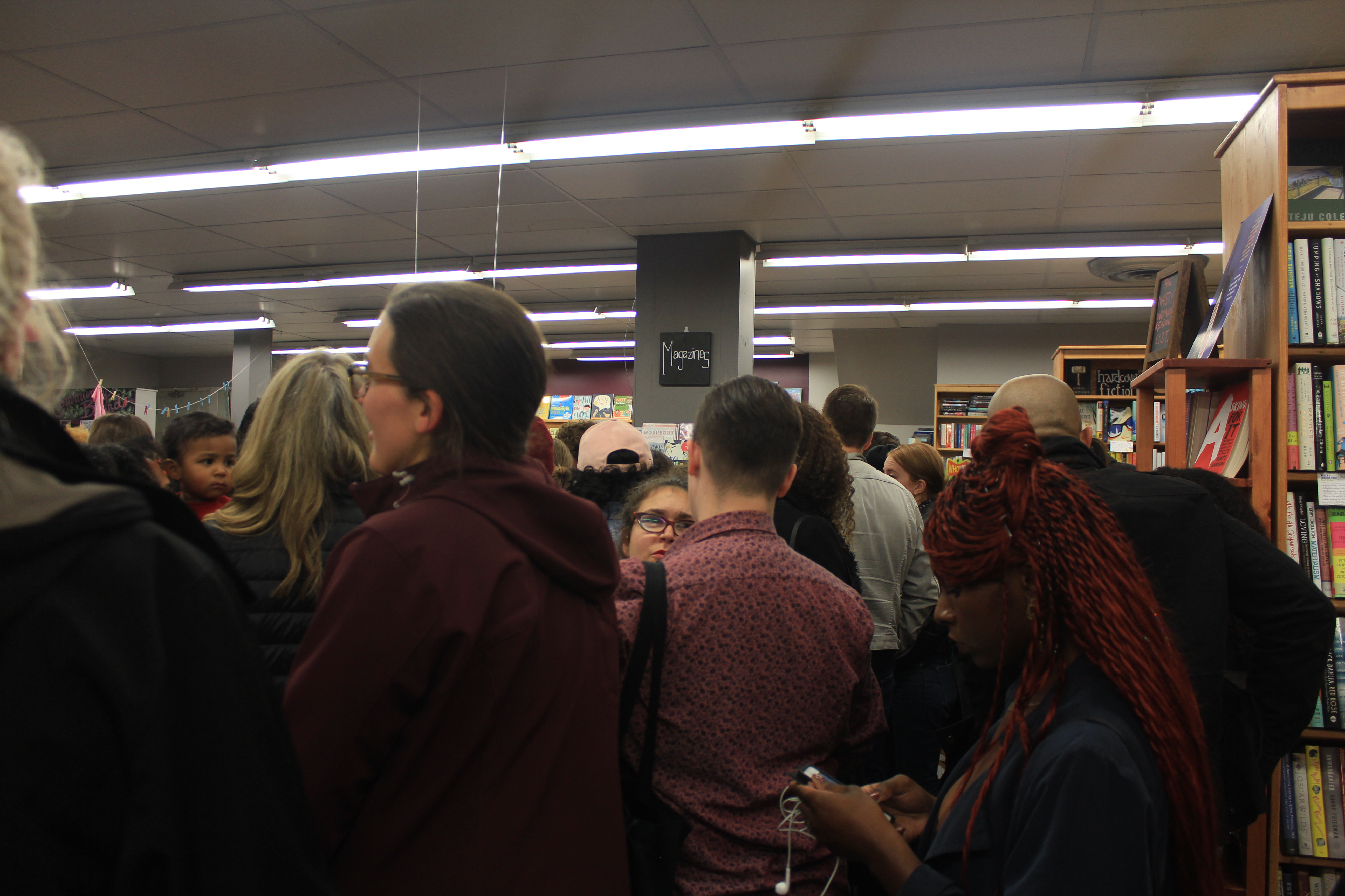 Poetry listeners cram into Women & Children First bookstore for a poetry reading by Eve Ewing and Denez Smith on Nov. 4, 2017. (Meredith Melland, 14 East)