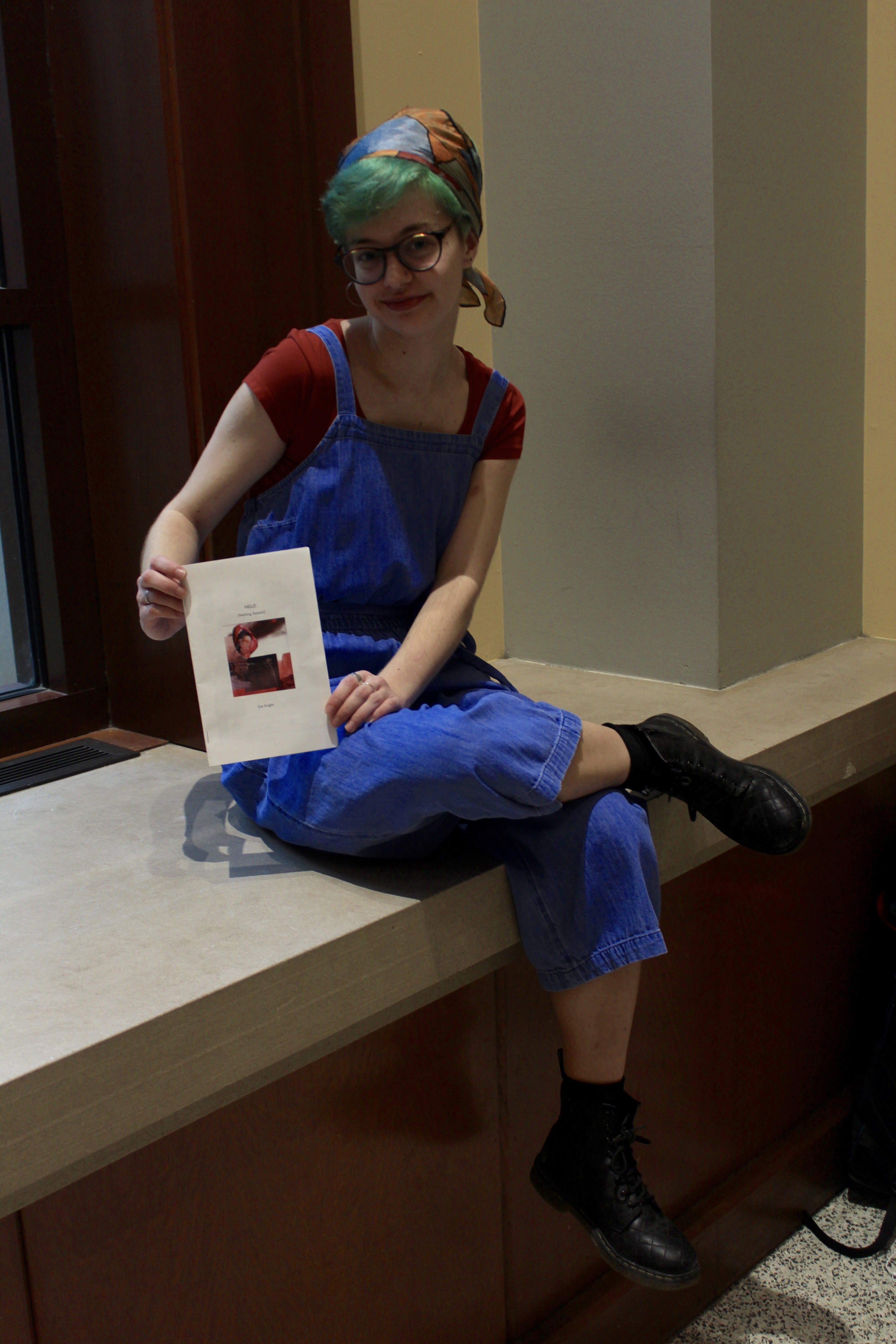 Poet and DePaul student Zoe Knight with her zine, “Melting Season.” (Meredith Melland, 14 East)