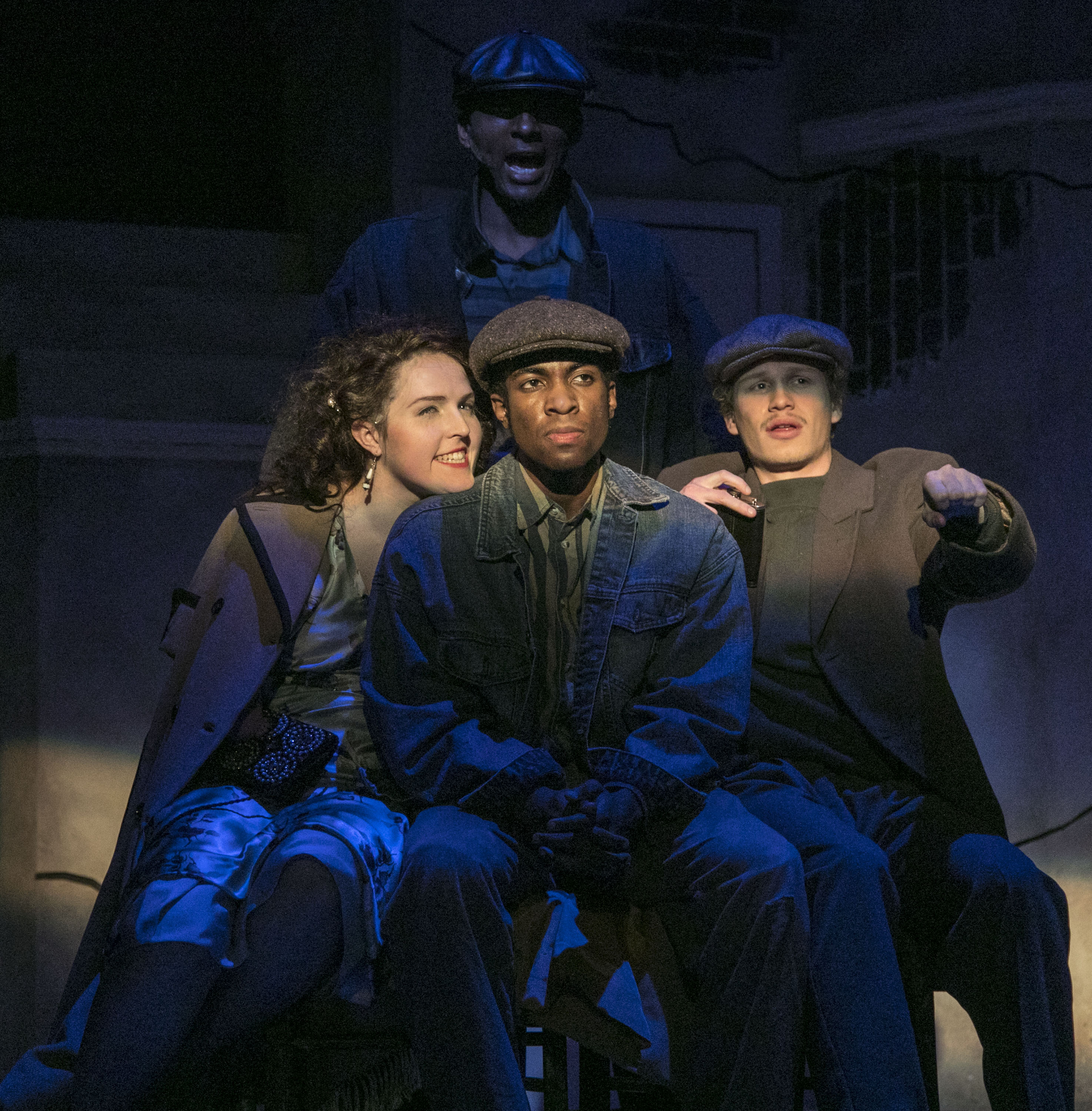 Constantly hounded by his inner demon, the Black Rat (Michael Morrow), standing, Bigger Thomas (Matthew James Elam) sits between Mary (Delaney Feener) and her socialist boyfriend Jan (Jack Lancaster) as they drive through the streets of Chicago in The Theatre School's production of "Native Son," being performed on the Fullerton Stage Feb. 9-18, 2018. Set in 1930s South Side Chicago, Bigger Thomas lands a job with a wealthy white family, but his fate is sealed when a violent act unleashes a chain of events that cannot be undone. The play, based on the novel by Richard Wright, is directed by DePaul graduate student Mikael Burke, and explores the systemic racism and poverty that oppressed Bigger Thomas from birth. (DePaul University/Jamie Moncrief)