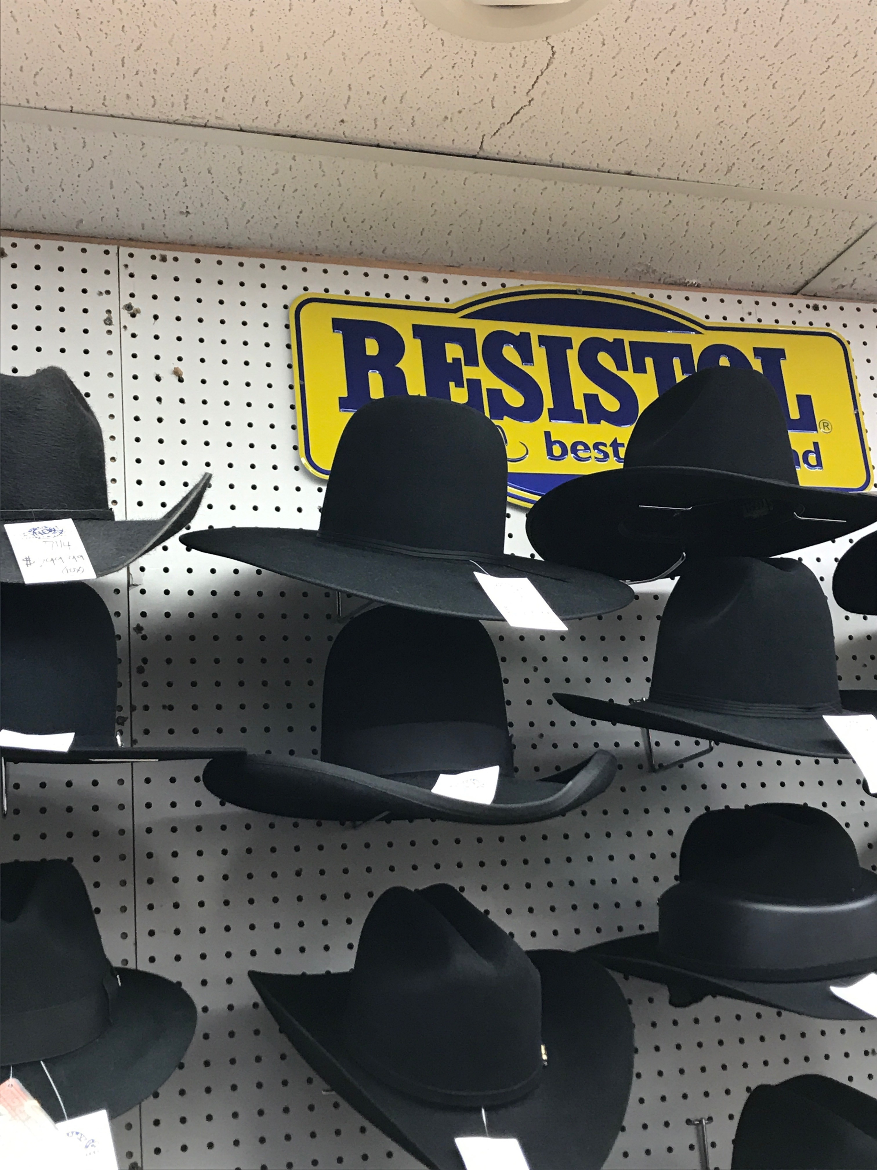 A full wall of short-brimmed hats on display at Alcala’s Western Wear