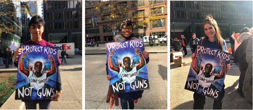 Left to right: Brian Martinez, Miriam Prater, Isabella Johnson at the March to the Polls rally holding the same "Protect Kids Not Guns" sign with a black woman's hands up signaling "don't shoot."